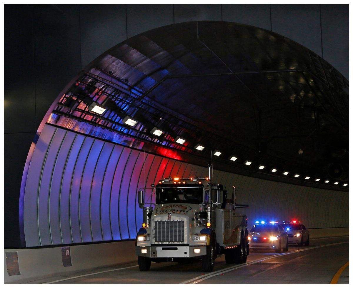 The last vehicle exists the westbound tunnel under police escort . The $1 billion Port of Miami tunnel was opened to limited traffic but expected to be opened to the general public at 3pm on Sunday, August 03, 2014.