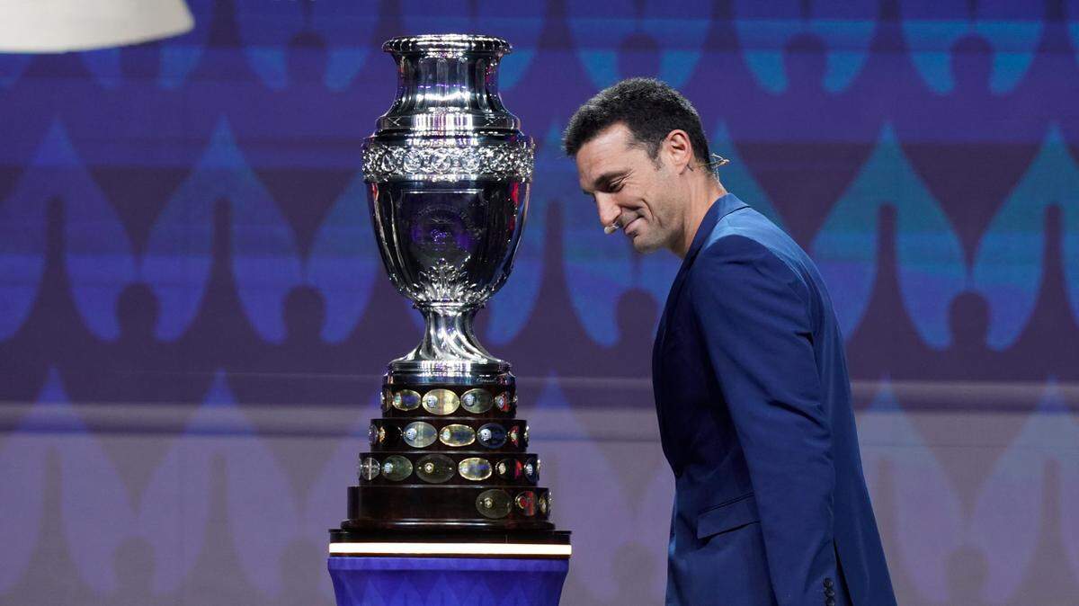 Argentina national coach Lionel Scaloni admires the Copa America trophy before the tournament draw at James L. Knight Center in Miami on Dec. 7, 2023. Argentina, the defending champion, will play against Peru at Hard Rock Stadium on June 29 in a group-stage game.