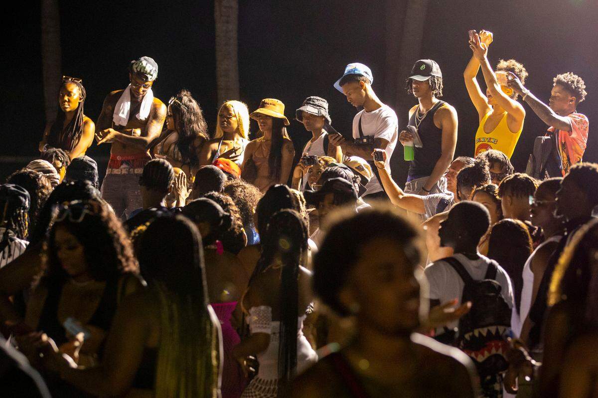 Crowds fill the beach walk during Spring Break in Miami Beach, Florida, on Saturday, March 19, 2022.