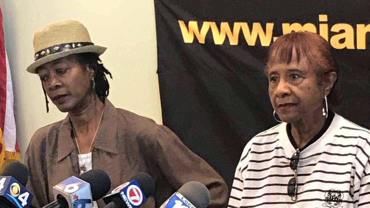 Courtney Johnson, left, and Gloria S. Burrows beside her, urged the man suspected of shooting and killing family member Danette Johnson-Simmons to give himself up during a press conference at Miami Gardens police headquarters on Wednesday. Johnson-Simmons was shot dead on April 4 when a fight erupted over her 3-year-old Yorkie named Chase