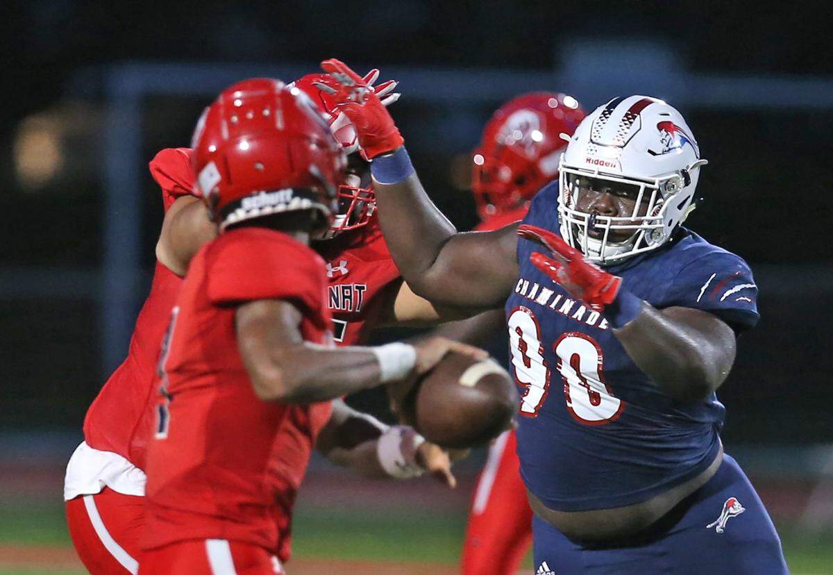 Chaminade-Madonna defensive tackle Allan Haye rushes Champagnat Catholic quarterback Tyous Taylor (1) at Chaminade-Madonna College Preparatory School, Hollywood, Florida, Friday, September 11, 2020.