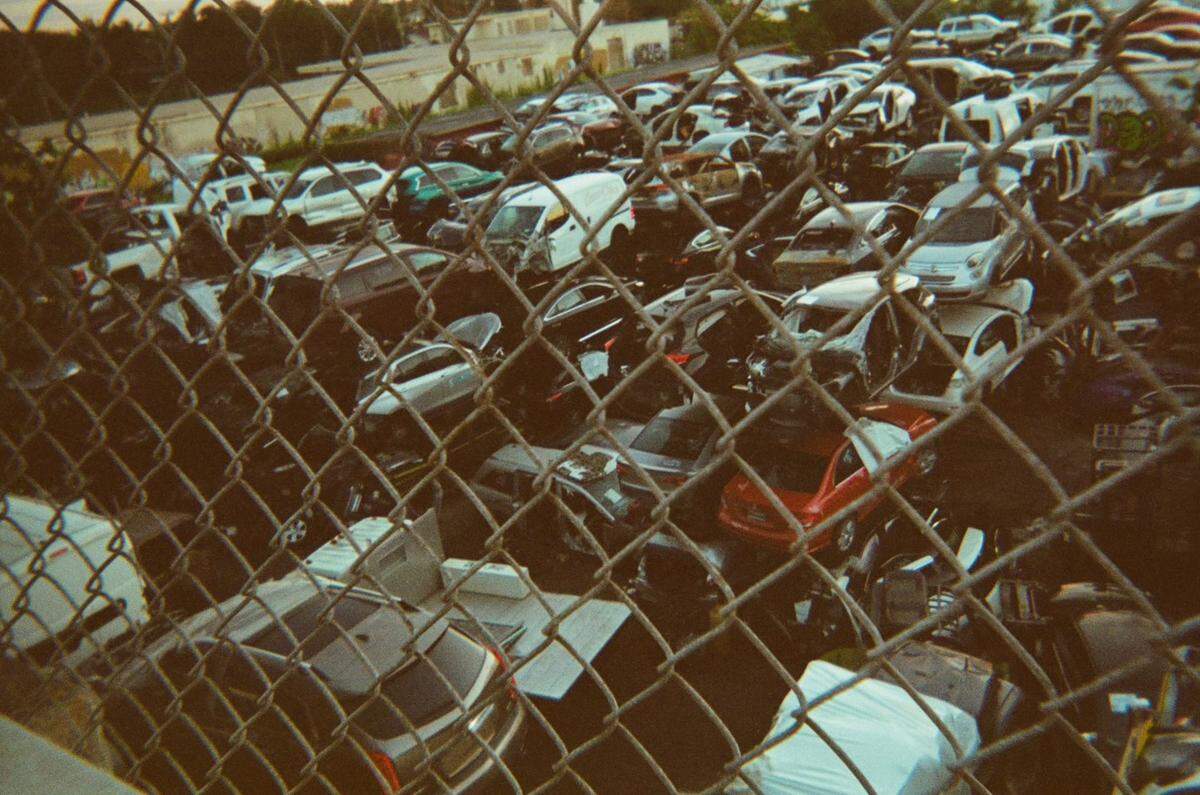 A photo features dozens of junk cars stacked high behind a wired fence. Amarnauth “Indian” Ramnaraime, who lived in the streets of Overtown for eight years, received a disposable camera from the Smile Trust, a nonprofit fighting to end homelessness, to photograph Miami through his lens. His art was featured during The Smile Trust’s “Smile Fuh Me” event hosted at the N’Namdi Contemporary Fine Art art gallery in Miami’s Little Haiti neighborhood on Sunday, December 5, 2021.
