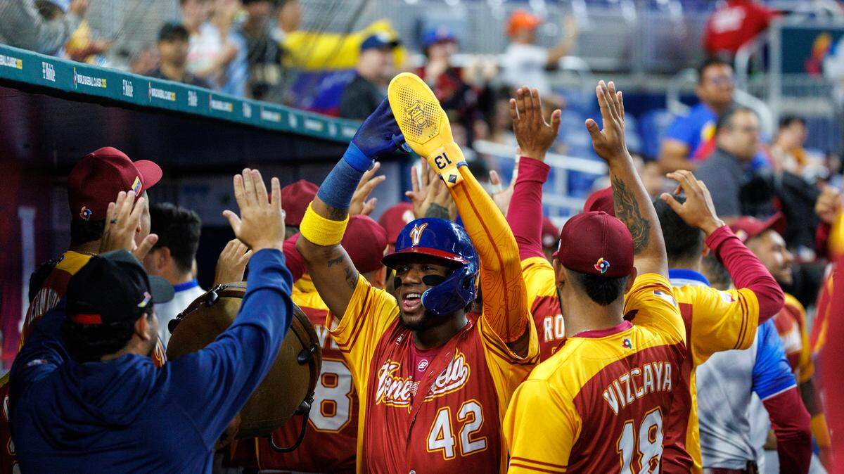 Venezuela center fielder Ronald Acuna Jr. (42) celebrates with teammates after scoring on a two runs single by teammate Eugenio Suarez (7) during the first inning of a Pool D game against Israel at the World Baseball Classic at loanDepot Park on Wednesday, March 15, 2023, in Miami, Fla.