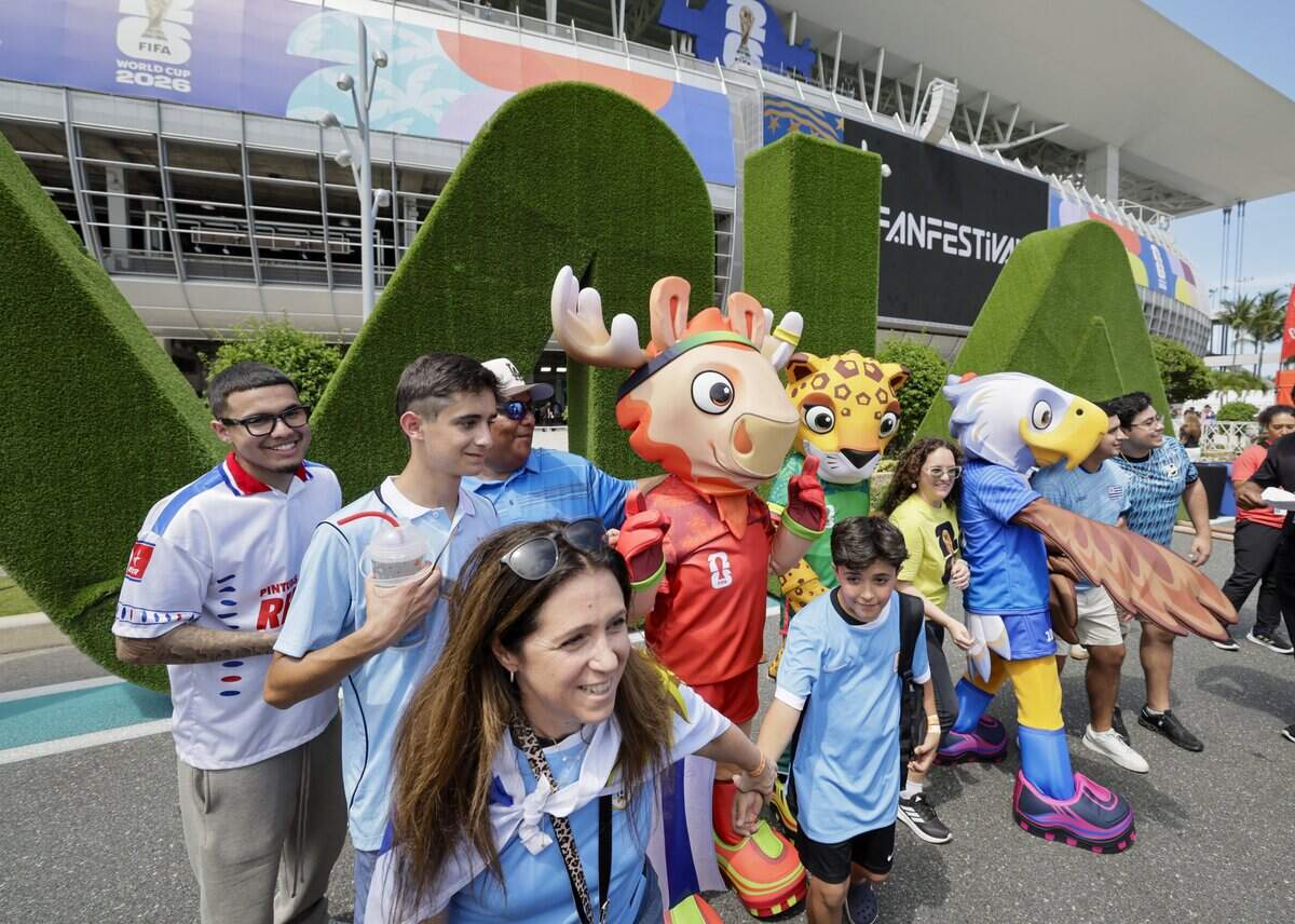 Soccer fans stand with mascots outside Miami Stadium before the start of Uruguay against Saudi Arabia FIFA World Cup opening match on Monday, June 15, 2026.