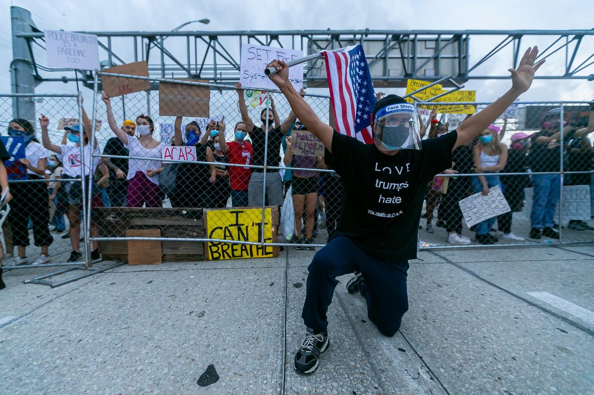 Protesters used a hole in a fence on the western edge of Wynwood to spill out onto northbound I-95 and block traffic during a Justice for George Floyd rally on Friday, June 5, 2020.