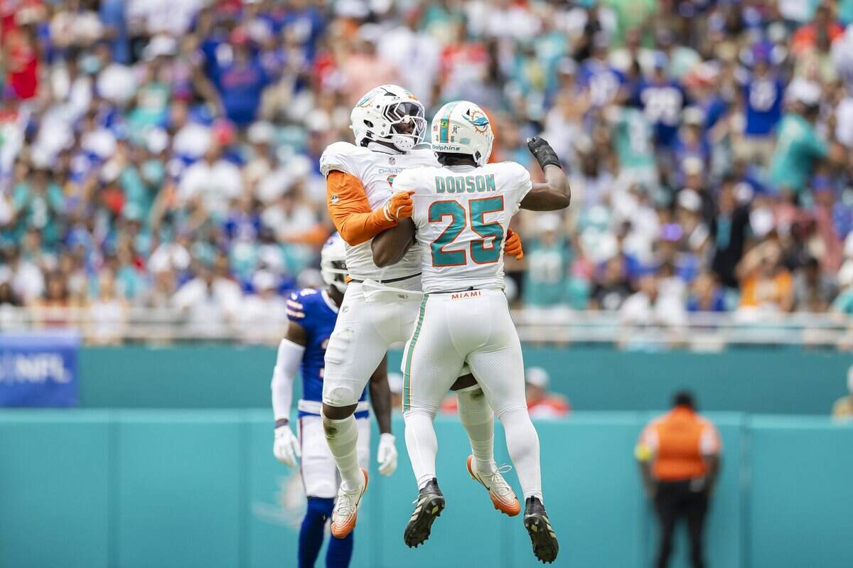 Miami Dolphins linebackers Matthew Judon (8) and Tyrel Dodson (25) celebrate after a play against the Buffalo Bills in the first half of their NFL game at Hard Rock Stadium on Sunday, Nov. 9, 2025, in Miami Gardens, Fla.
