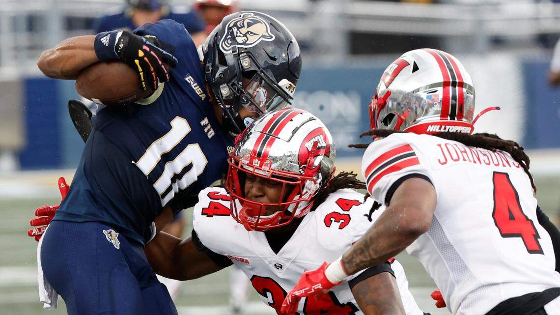 FIU Golden Panthers wide receiver Kris Mitchell (10) catches a pass as Western Kentucky Hilltoppers linebacker Koron Hayward (34) attempts to make the stop in the first half at FIU Riccardo Silva Stadium in Miami on Saturday, November 25, 2023.