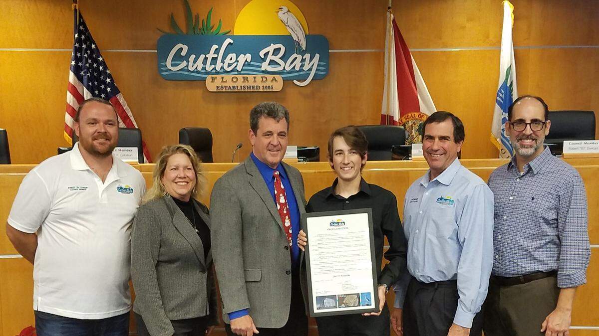 Jett Forsythe of Cutler Bay High School received a proclamation from Cutler Bay Mayor Tim Meerbott and fellow council members for helping to save lives while boating along Biscayne Bay, the Atlantic Ocean and near Miami Beach’s South Pointe Park. From left: Councilman Robert Duncan, Vice Mayor Sue Ellen Loyzelle, Meerbott, Jett, Councilman Michael Callahan and Councilman Roger Coriat.