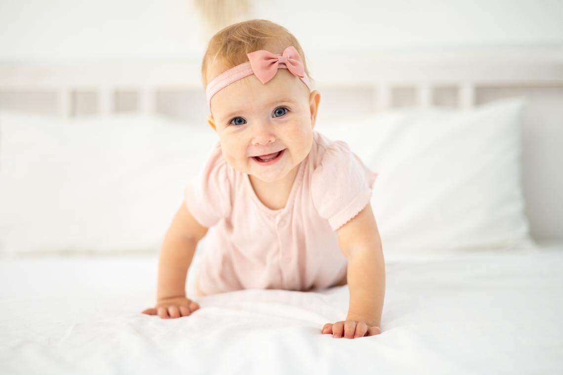 newborn baby girl wearing pink bow