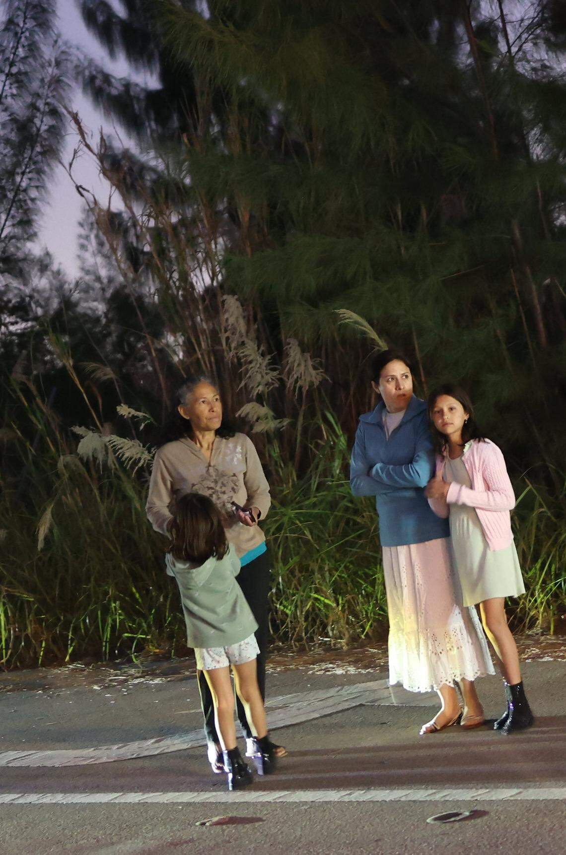 Residents of Modern 45 stand outside the complex watching the smoke rise as fire crews battle a blaze at Covanta Energy in Doral on Feb. 12, 2023.