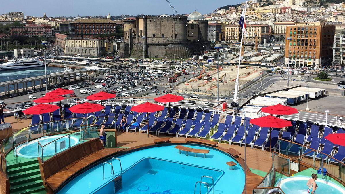 The port at Naples, Italy, as seen from the pools at the aft end of Carnival Horizon. Carnival has taken many Americans on their first visit to Europe.