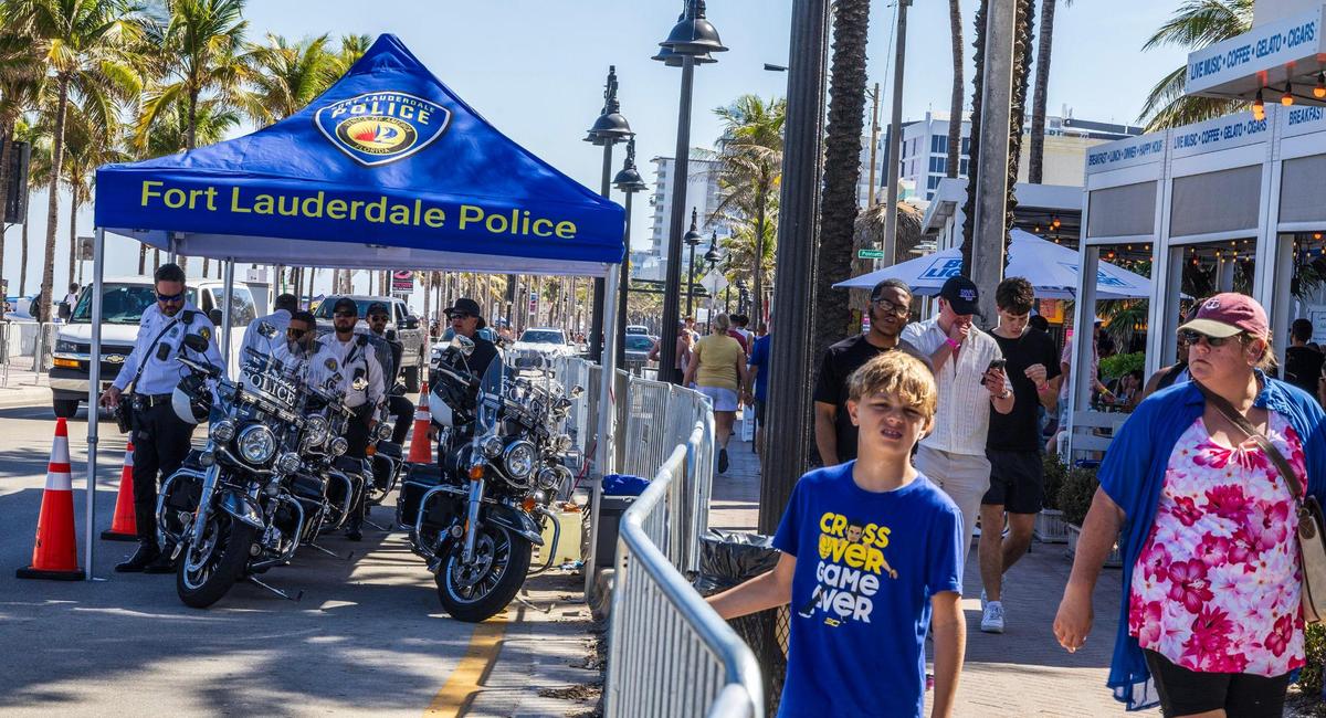 Police officers seen as spring breakers enjoy the nice weather at Fort Lauderdale Beach on Thursday March 20, 2025.