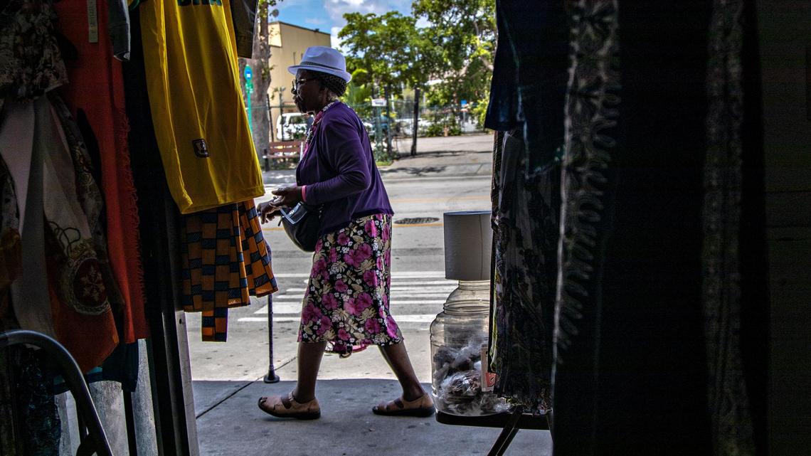 Walk-in clienteles numbers are dwindling and many business owners don’t if they can survive much longer. “Rent is up high,” said Jefferson, 62, pointing to the bulging veins in her forehead and speaking in an agitated mix of Creole and English. “I feel stress, terrible. I don’t have enough money.” Jefferson’s plight encapsulates the trepidation and uncertainty that’s enveloping the neighborhood where she has lived and worked since arriving from Haiti as part of a wave of refugees and boat people four decades ago. Little Haiti is up for grabs. And the future of one of Miami’s poorest, yet most singular and misunderstood, communities hangs precariously in the balance. Customer passes-by after a short visit Marie Desir’s thrift shop where she has lost most of her inventory due to a leaky roof.