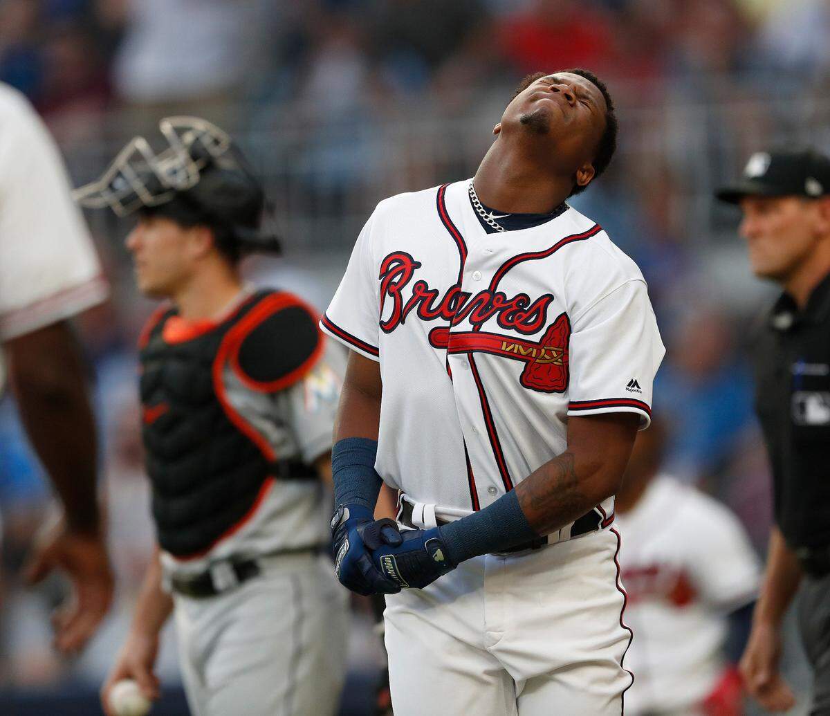 Atlanta Braves left fielder Ronald Acuna Jr. (13) reacts after being hit by a pitch from Miami Marlins starting pitcher Jose Urena in the first inning of a baseball game Wednesday, Aug. 15, 2018, in Atlanta. (AP Photo/John Bazemore)