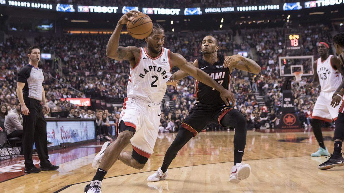 Toronto Raptors Kawhi Leonard, left, drives past Miami Heat Rodney McGruder during first half NBA basketball action in Toronto on Sunday, Nov. 25, 2018.