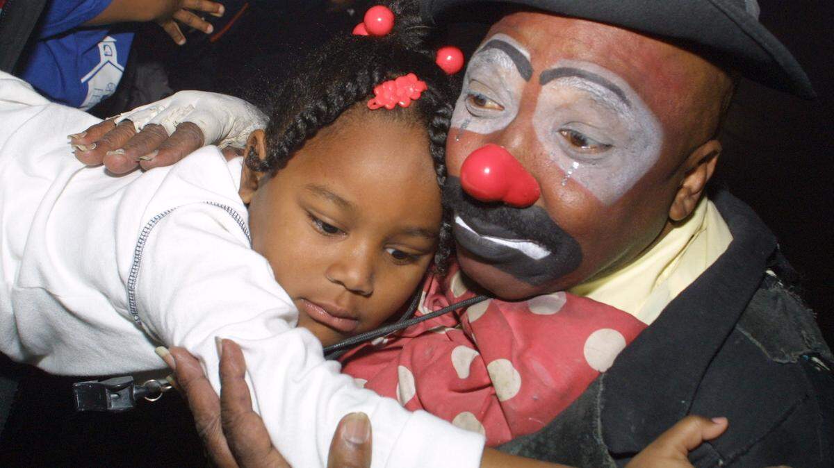 Coconut Grove-born Robert Dunn, better known as Onionhead, the clown from the hood, hugs a child at a recent UniverSoul Circus show. The circus will be at Miramar Regional Park until Feb. 23.
