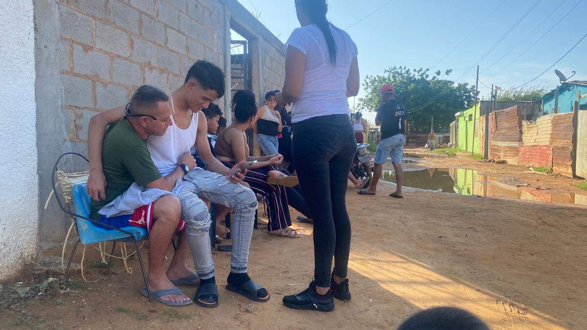 Jonferson Valera Yamarte sits with his father outside his home in Maracaibo, Venezuela. Photo: Gustavo Ocando Alex