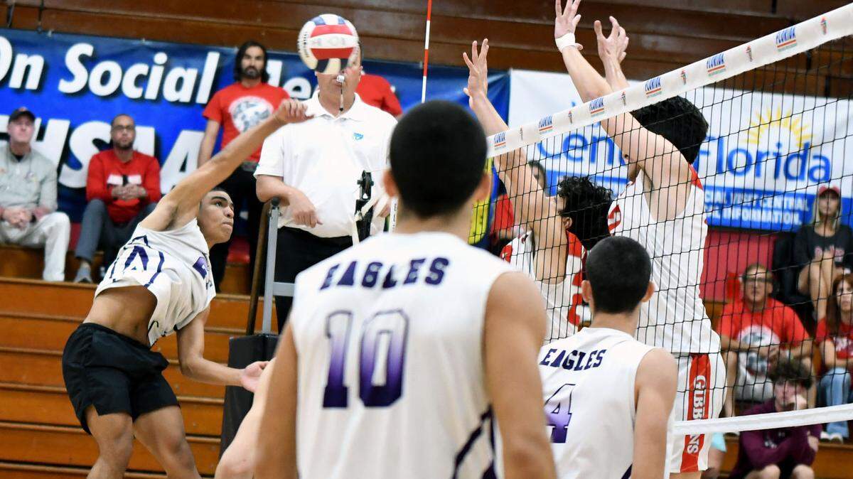 Miami Southwest’s Marlon Albornoz drills a shot at the Cardinal Gibbons defenders during the FHSAA boys volleyball state championship game on Saturday at Polk State College in Winter Haven, Fla.