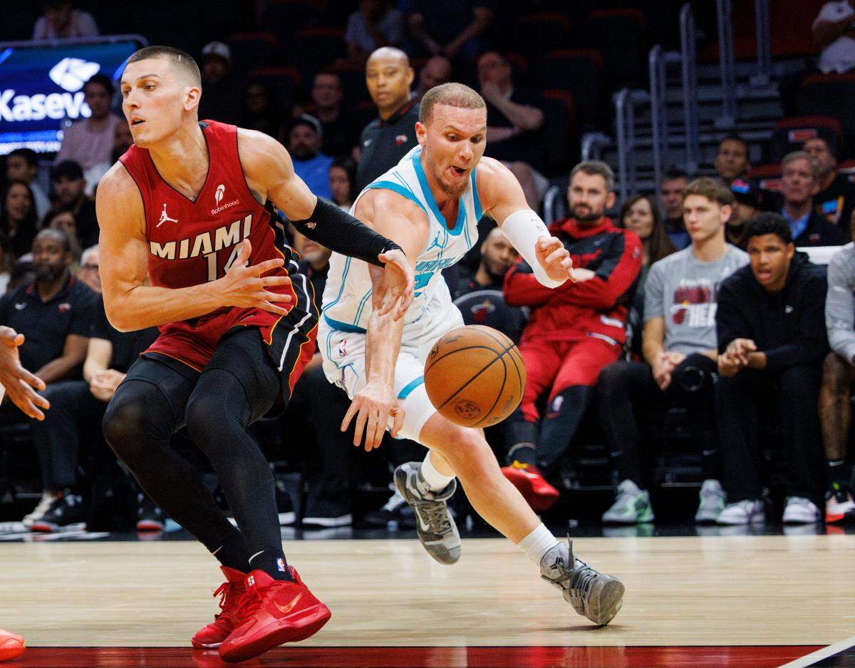 Charlotte Hornets guard Malachi Flynn (22) steals the ball from Miami Heat guard Tyler Herro (14) during the second half of a game on Monday, March 10, 2025, at the Kaseya Center in downtown Miami, Fla.