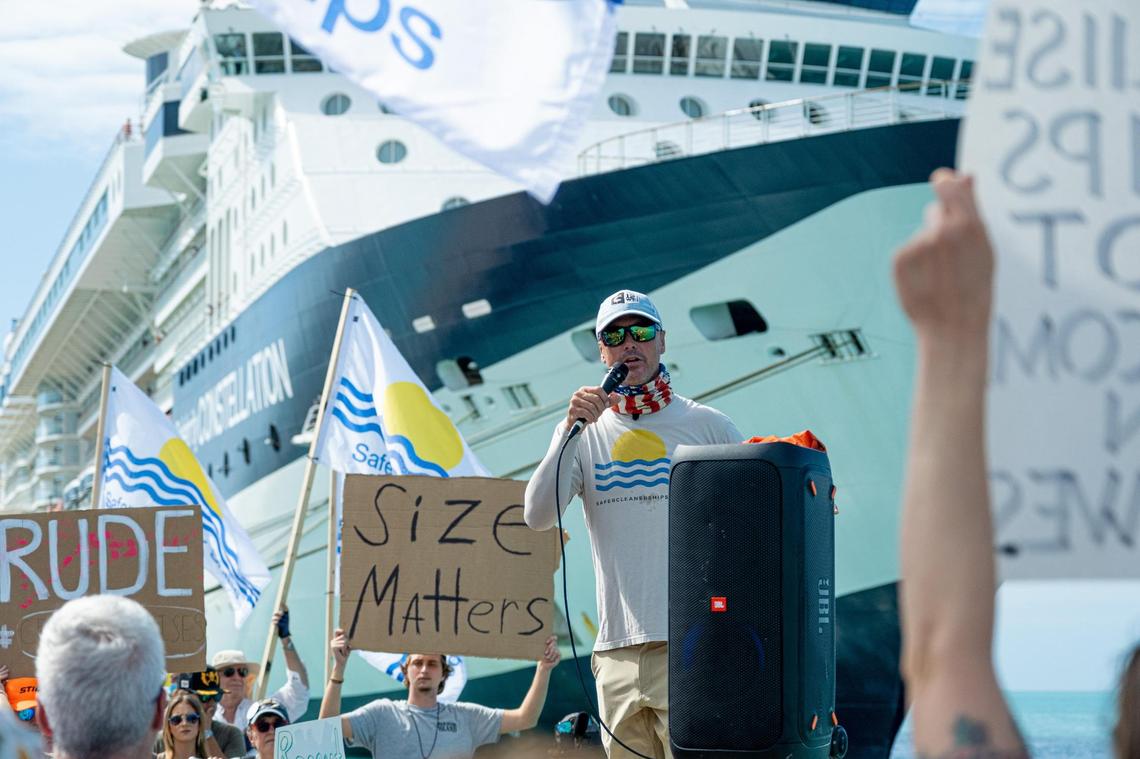 Key West fisherman Will Benson speaks to a crowd of protesters on Feb. 5, 2022, as a large ship arrives.