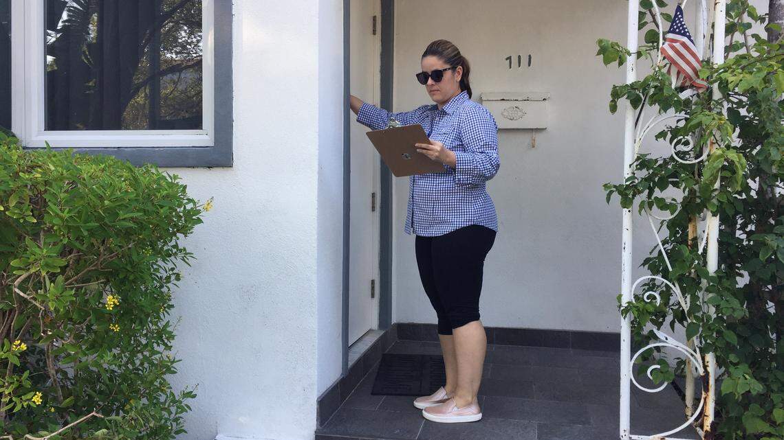 Nicole Florin knocks on a neighbor’s door as part of her efforts to stop Miami Beach’s planned project to make Lakeview climate-change ready by raising roads.