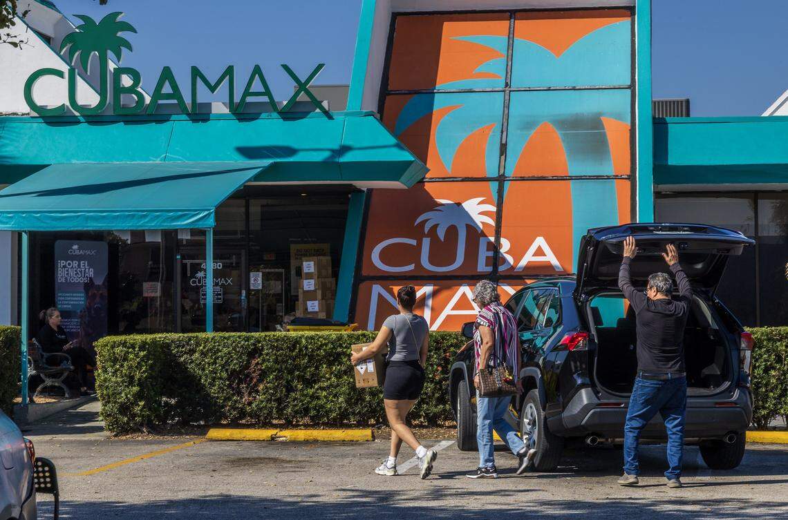 A woman brings a box with items to be shipped to relatives in Cuba at a Cubamax Travel office located at 4380 w 12th Avenue, in Hialeah, as residents on the Island are dealing with power outages and shortages of food, medicine, hygiene products, and fuel. Cubamax, is a shipping company to Cuba, with offices in Miami-Dade County. On Friday, February 13, 2026.