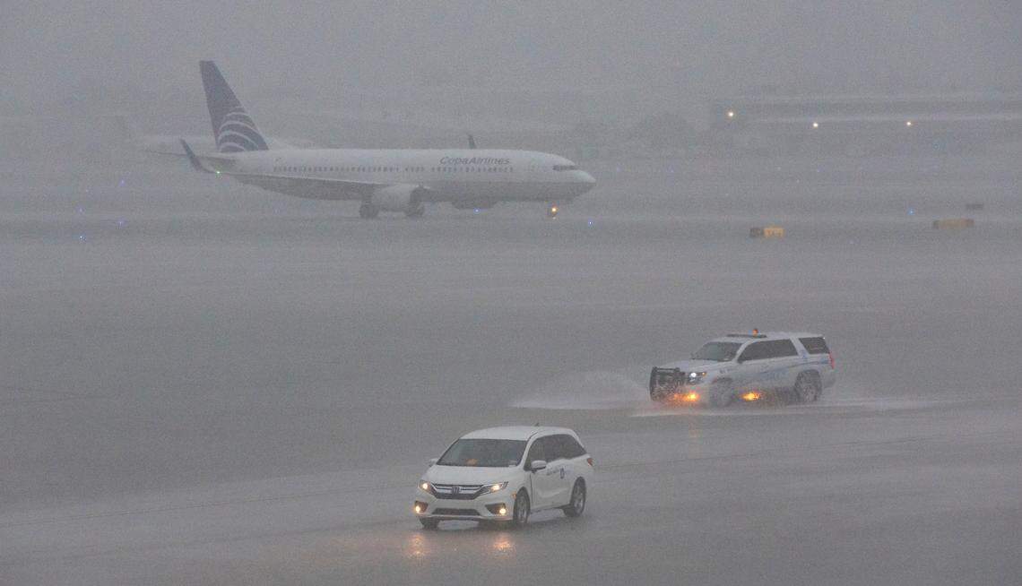 An airplane is seen on the runway as heavy rain falls over the Fort Lauderdale-Hollywood International Airport on Wednesday, June 12, 2024, in Fort Lauderdale, Fla. Many flights were either canceled or delayed due to the bad weather.