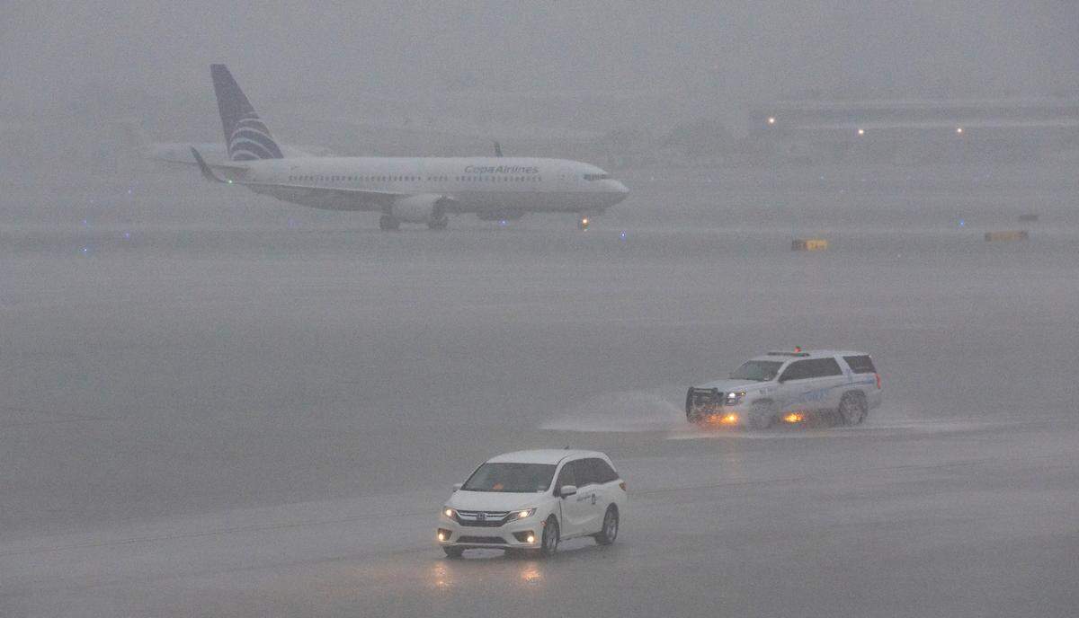An airplane is seen on the runway as heavy rain falls over the Fort Lauderdale-Hollywood International Airport on Wednesday, June 12, 2024, in Fort Lauderdale, Fla. Many flights were either canceled or delayed due to the bad weather.