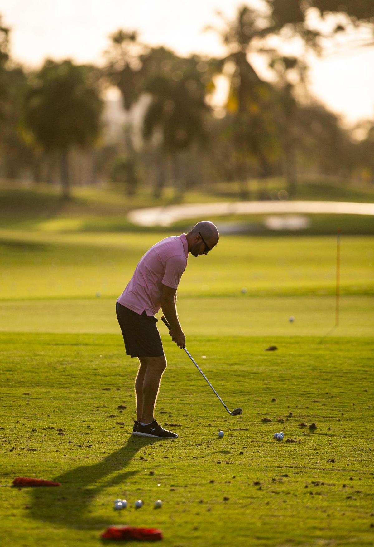 A golfer practices his swing at Melreese golf course in Miami on Wednesday, Jan. 19, 2022.