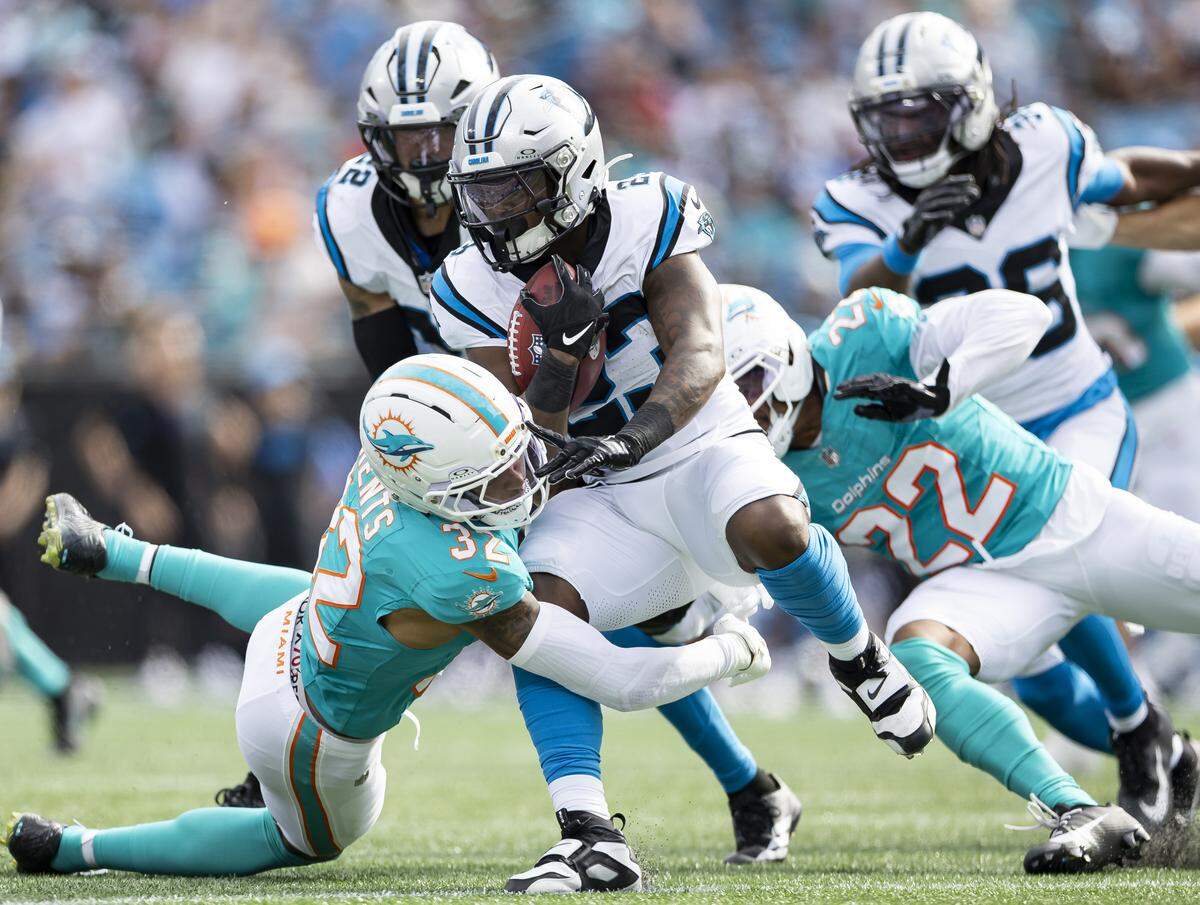 Miami Dolphins cornerback Julius Brents (32) tackles Carolina Panthers running back Trevor Etienne (23) in the second half of their NFL game at the Bank of America Stadium on Sunday, Oct. 5, 2025, in Charlotte, N.C.