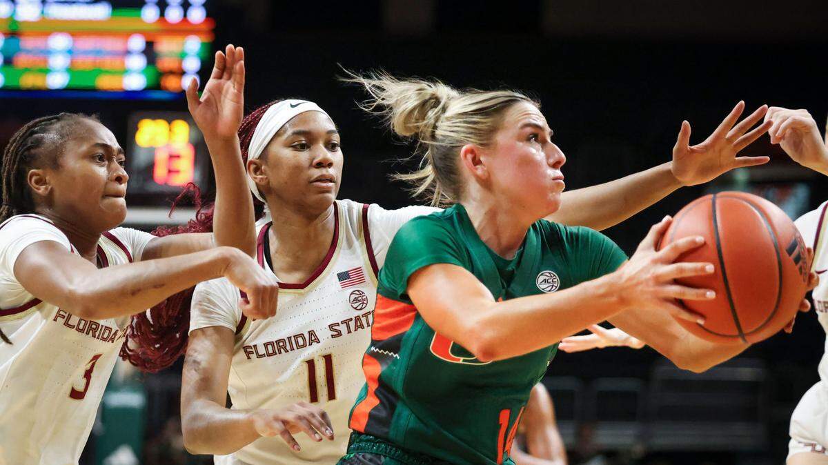 Miami Hurricanes guard Haley Cavinder (14) is chased by Florida State Seminoles guard O’Mariah Gordon (3) and Sydney Bowles (11) during the third quarter of a game on Sunday, Feb. 16, 2025, at Wastco Center in Coral Gables, Fla.