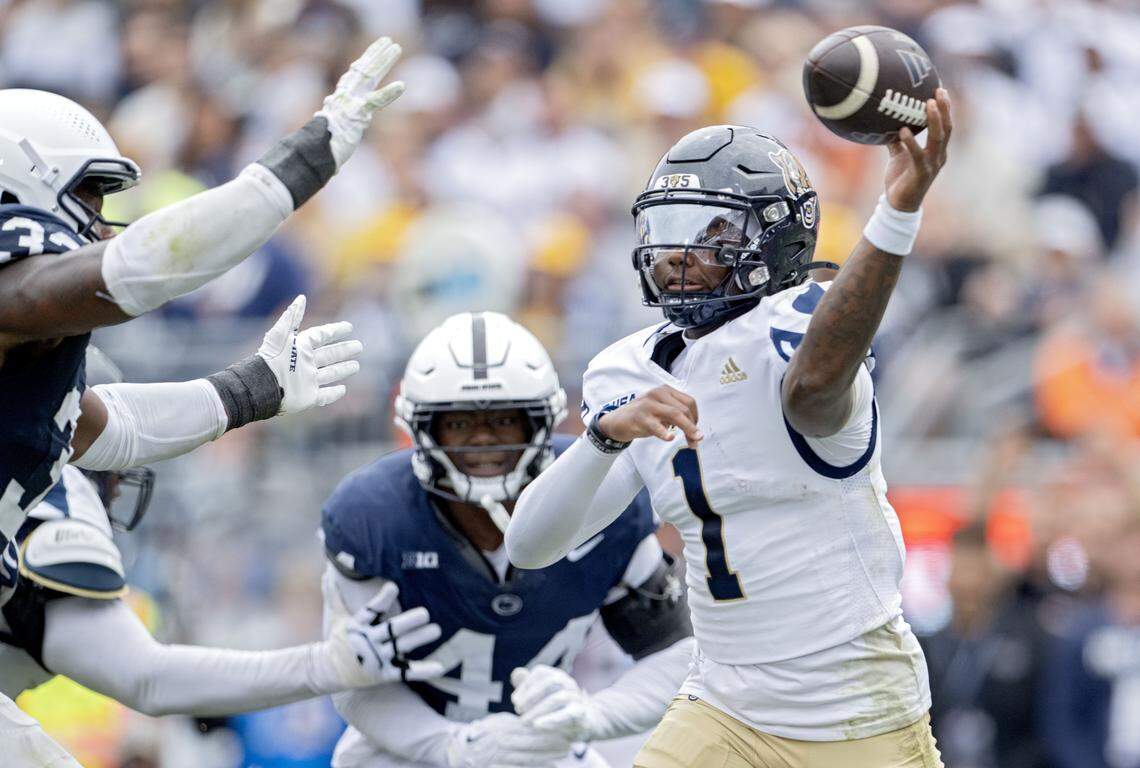 FIU quarterback Keyone Jenkins makes a pass as he is pressured by Penn State defenders during the game on Saturday, Sept. 6, 2025 at Beaver Stadium.