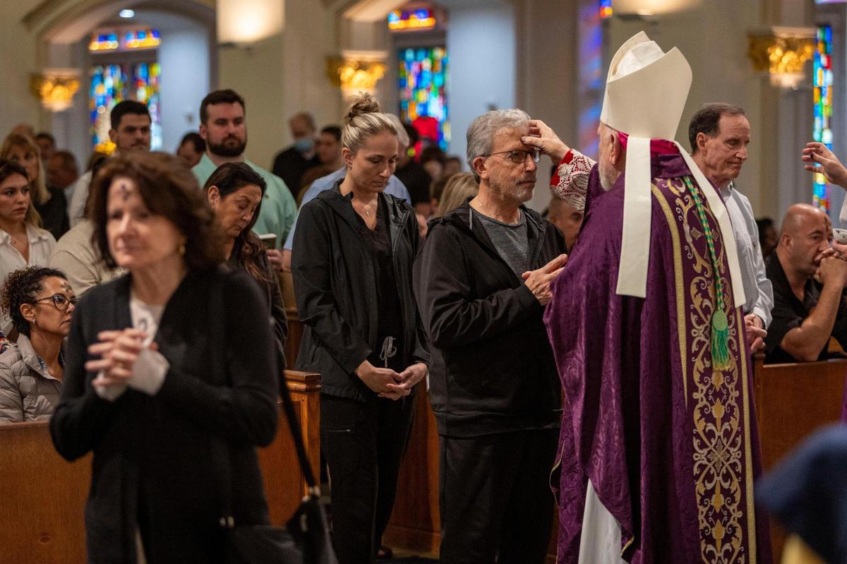 Fort Lauderdale, FL- March 5, 2025 - Archbishop Thomas Wenski applies Ashes to the faithful as he celebrates mass at St. Anthony Church in Fort Lauderdale, Florida on the occasion of Ash Wednesday. Ash Wednesday marks the beginning of the 40-day Lenten season, a time of penance and preparation for the commemoration of the passion and death of Jesus Christ and his ultimate resurrection on Easter Sunday.