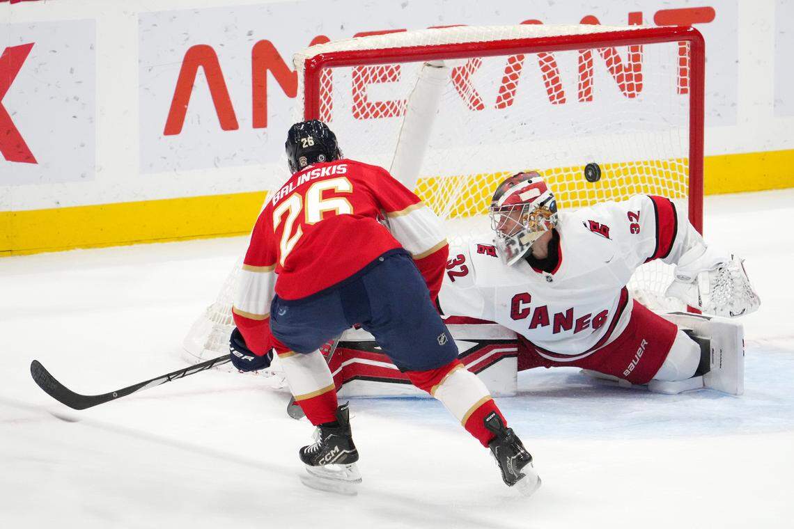 Nov 10, 2023; Sunrise, Florida, USA; Florida Panthers defenseman Uvis Balinskis (26) scores a goal past Carolina Hurricanes goaltender Antti Raanta (32) during the first period at Amerant Bank Arena. Mandatory Credit: Jasen Vinlove-USA TODAY Sports