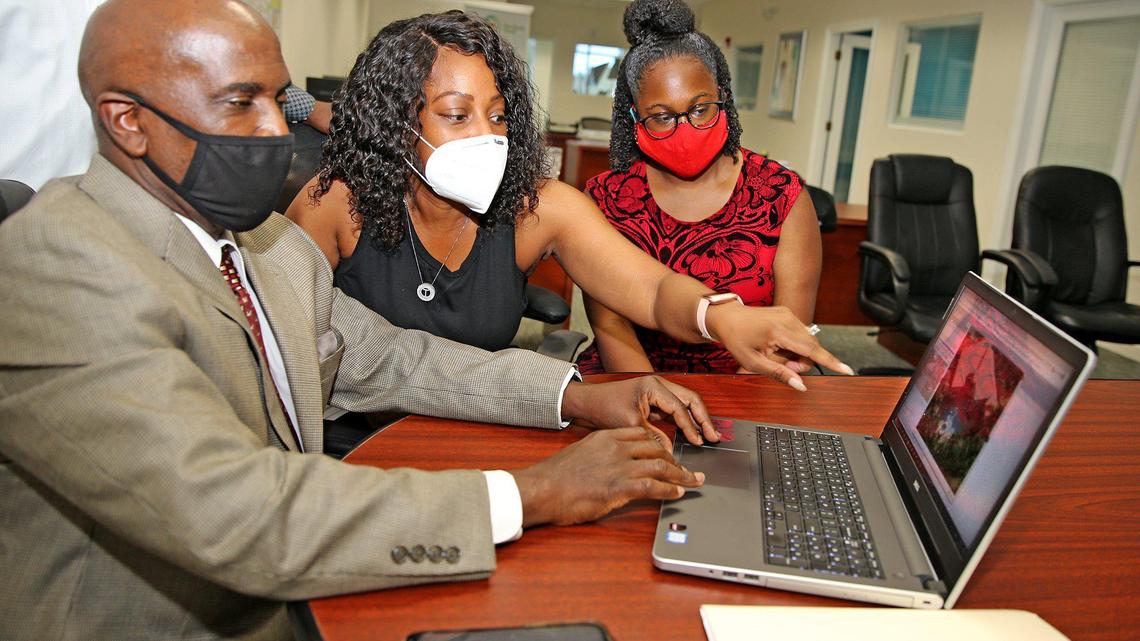 Tiffany Offord and her daughter Raelle work with realtor Robert Henry at Miami Way Realty in Miami, Florida, July 10, 2020. There has been a decline in home-ownership for Blacks and Hispanics in South Florida from 2012 to 2018. Whites also saw a decline but Blacks and Hispanics experienced the biggest drops.