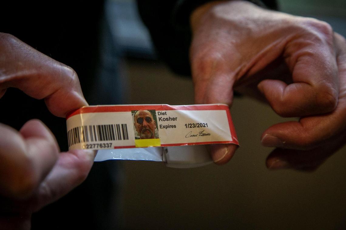 Miami, Florida, January 29, 2021 - Heriberto Delvalle shows his Krome Detention Center wristband in his hotel room in Miami after being released by immigration officials. The 70-year-old man born in Cuba has spent nearly half his life behind bars. Convicted of attempted murder after shooting the brother of a man he believed to be his wifes lover, Delvalle served 15 years in a Florida prison. He was released only to be taken straight into custody by immigration officials where he has been detained for over 11 years.