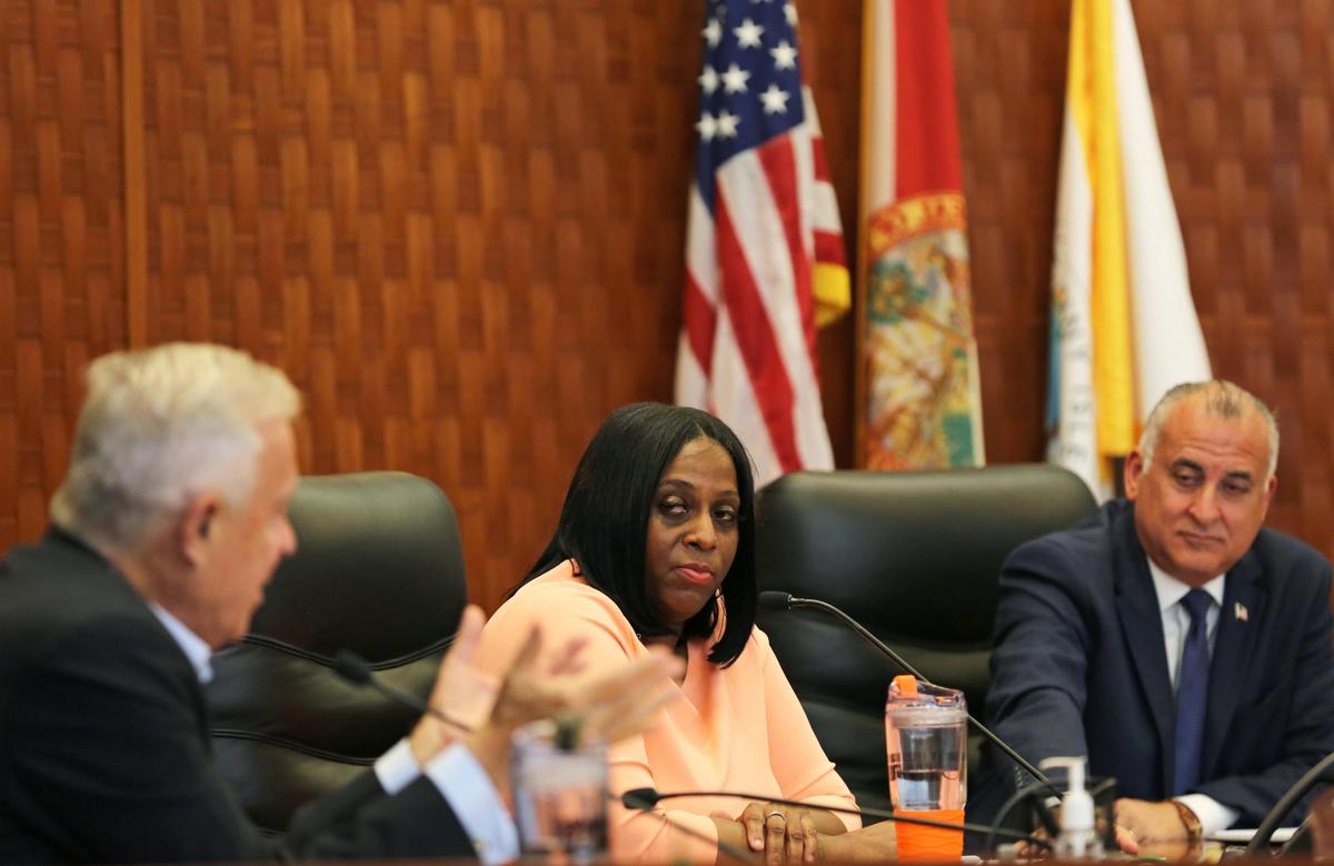 Miami-Dade County mayoral candidate Monique Nicole Barley watches moderator Michael Putney ask a question during a debate at the government center in Sunny Isles Beach, Florida, on Monday, March 9, 2020. At right is candidate Esteban “Steve” Bovo.