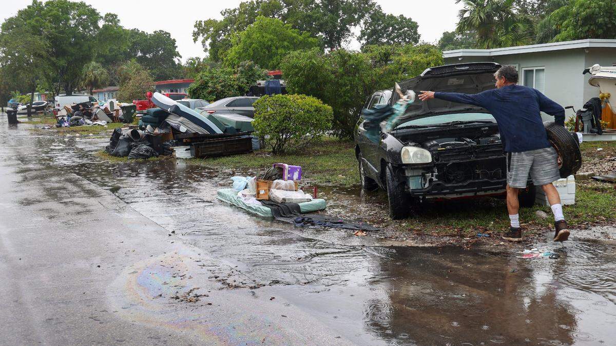 As the rain returned on Monday, April 17, resident Paul Guerrero continued to clean out his home while discarded water-damaged items were piled up on the neighborhood street.