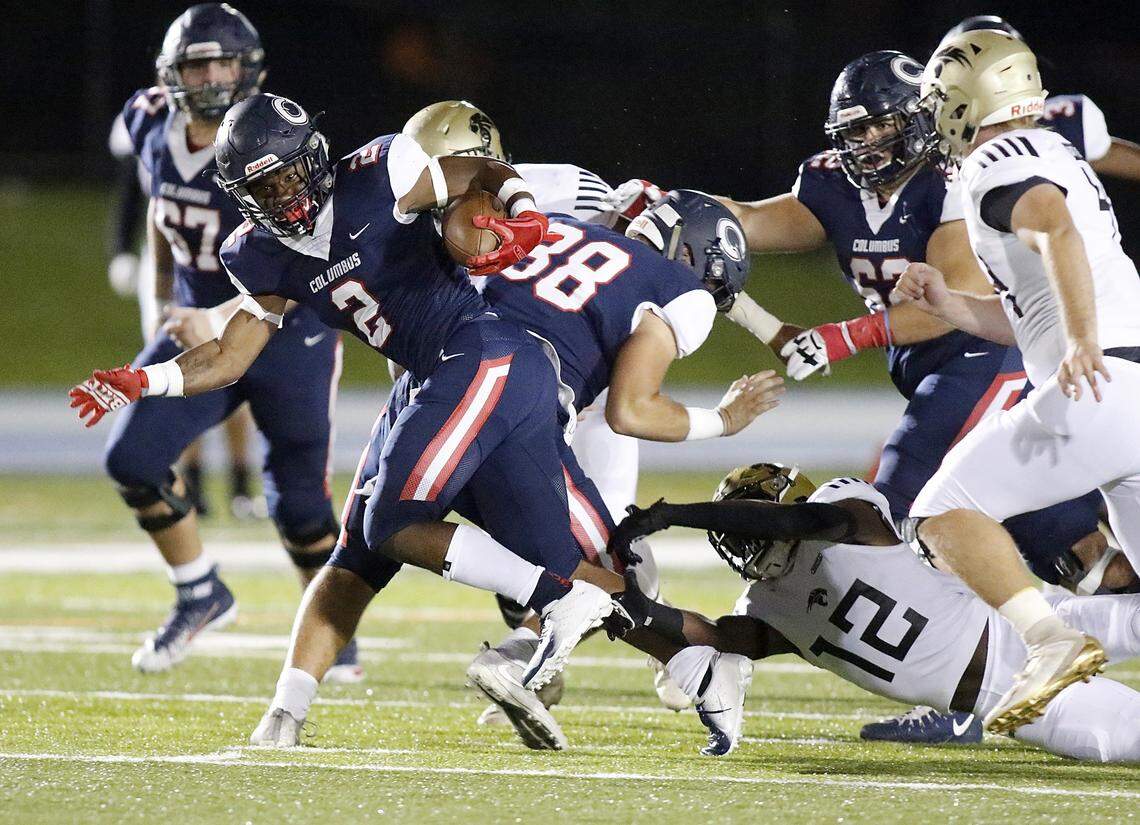 Columbus Explorers’ running back Henry Parrish Jr. (2) tries to break free from Western Wildcats’ defensive back Websley Etienne during the Region 4-8A football championship final game on Thursday, November 21, 2019 at Tropical Park stadium in Miami
