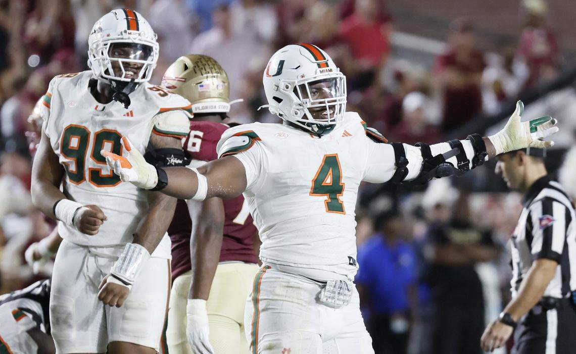 Miami Hurricanes defensive lineman Rueben Bain Jr. (4) and defensive lineman Ahmad Moten Sr. (99) react after defensive back Keionte Scott (0) recovers a fumble in the first half against the Florida State Seminoles at Doak Campbell Stadium in Tallahassee, Florida, on Saturday, October 4, 2025.