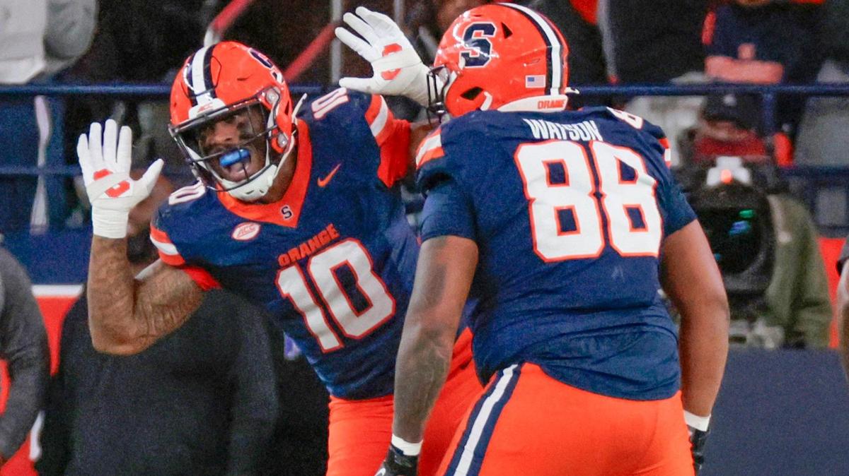 Miami Hurricanes quarterback Cam Ward (1) is sacked by Syracuse Orange defensive lineman Fadil Diggs (10) in the second half of their NCAA football game in the JMA Wireless Dome at Syracuse University, Syracuse, New York on Saturday, November 30, 2024.