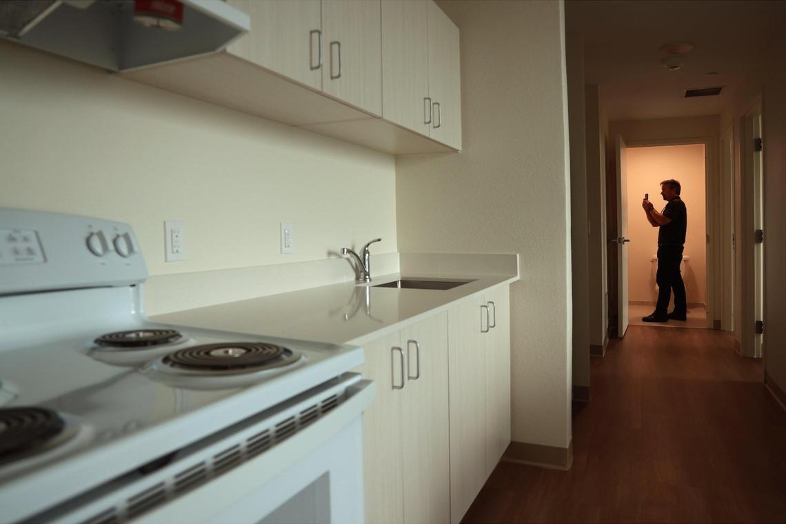 Eduardo Merille, FIU’s assistant vice president brand marketing, tours the new student housing suite at Tamiami Hall, a new 13-story dorm that FIU is opening in August.