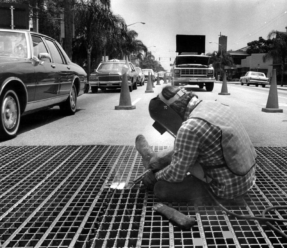 A DOT worker in 1985 replaces the grating on the bridge on Biscayne Boulevard just south of 79th Street.