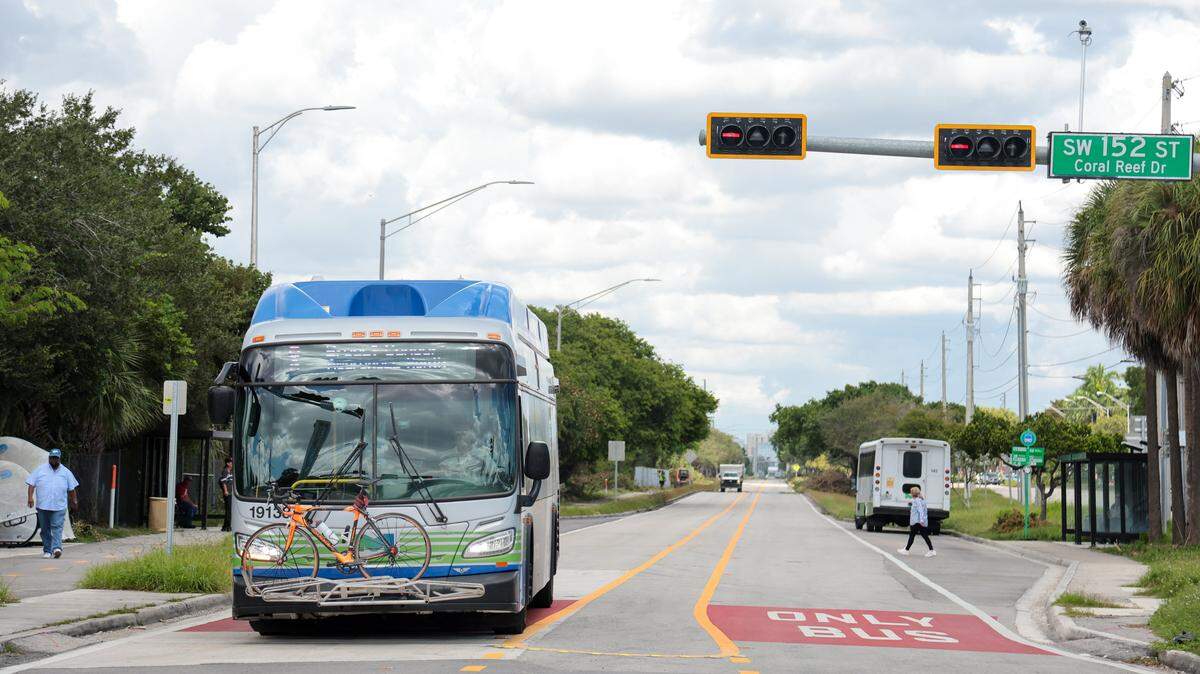 A bus waits for a green light on a dedicated bus lane by the Metro Express BRT station at SW 152nd Street on the South Dade TransitWay in Miami, Florida, Wednesday, October 1, 2025.