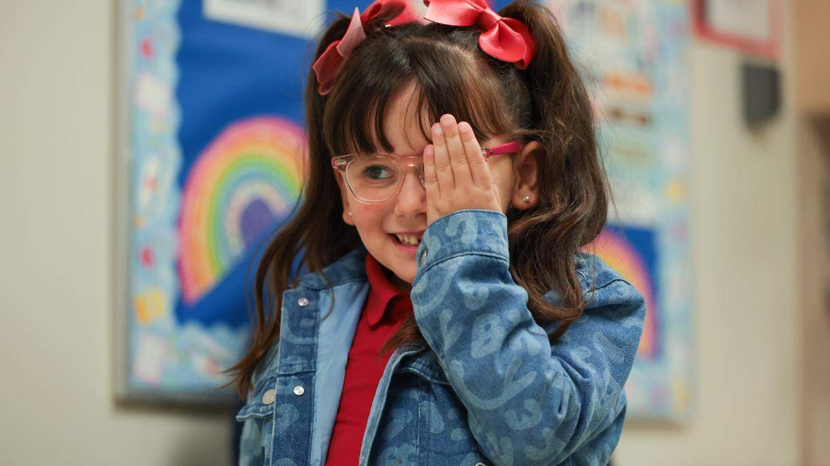 Evangelina Gonzalez, a 6-year-old kindergartner, covers her left eye as she reads a row of letters on the chart during an eyesight exam performed by school nurse Ruby Ramirez at the clinic at Spanish Lake Elementary School in Hialeah, Florida, Tuesday, Jan. 13, 2026. 