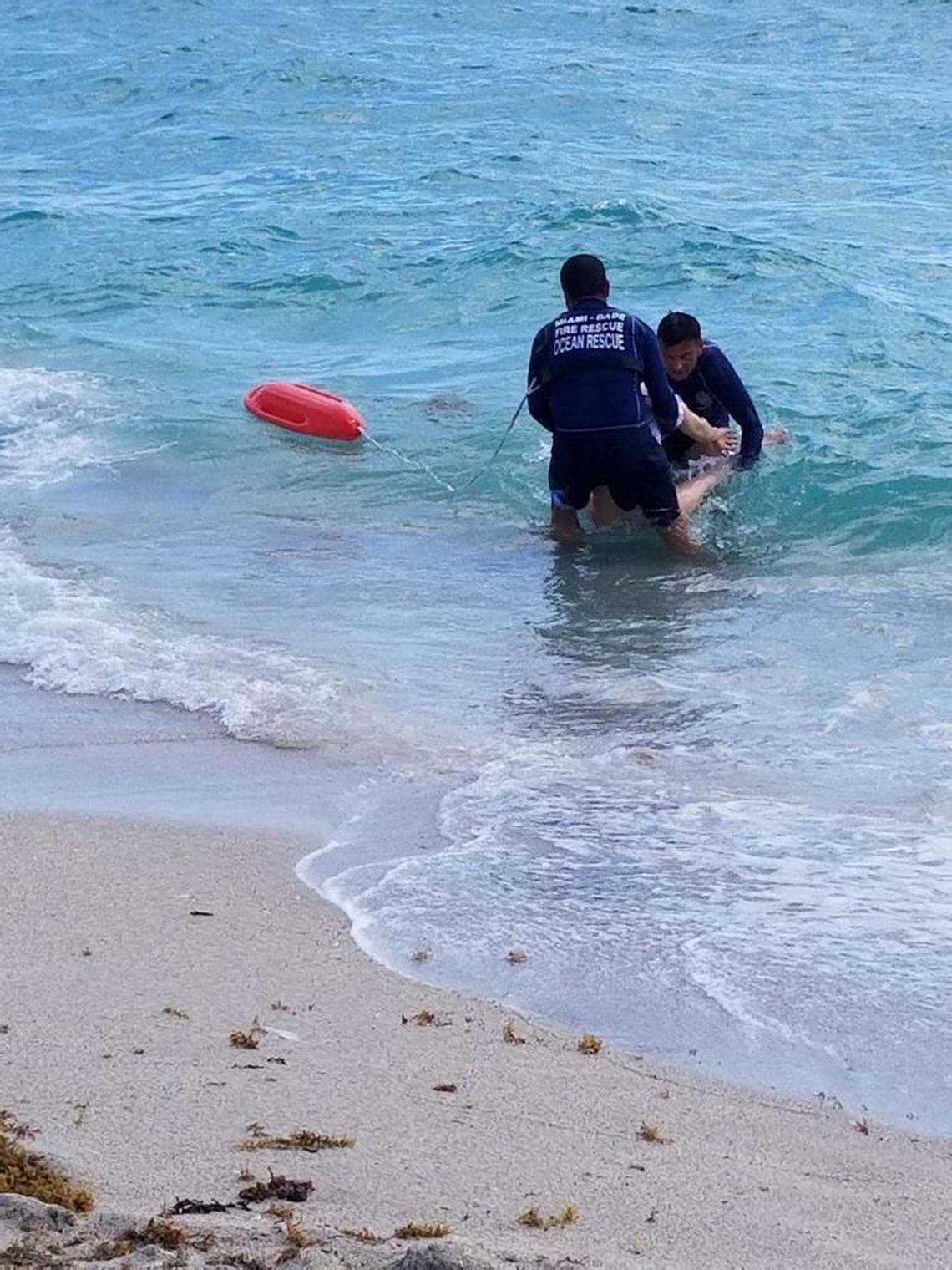 Miami-Dade Ocean Rescue lifeguards bring a distressed swimmer to shore before beach closures mandated by the coronavirus pandemic.