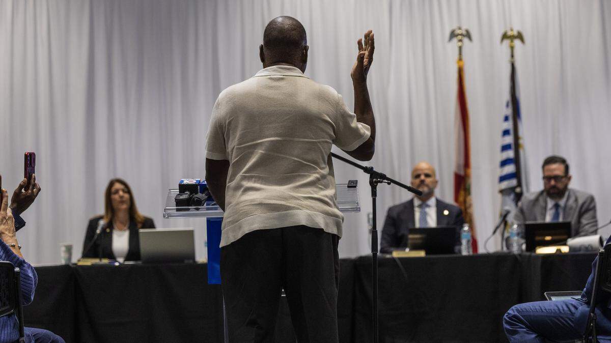 Miami Dade College Board of Trustees members and President Madeline Pumariega, listen as retired Prof. Marvin A Dunn speaks during a special meeting held to discuss the potential real estate transactions including the authorization to convey a +/-2.63 acre surface parking lot at the Wolfson Campus for further conveyance for a Presidential Library for Donald J. Trump, celebrated at the MDC Hialeah Campus, on Wednesday, December 02 , 2025.