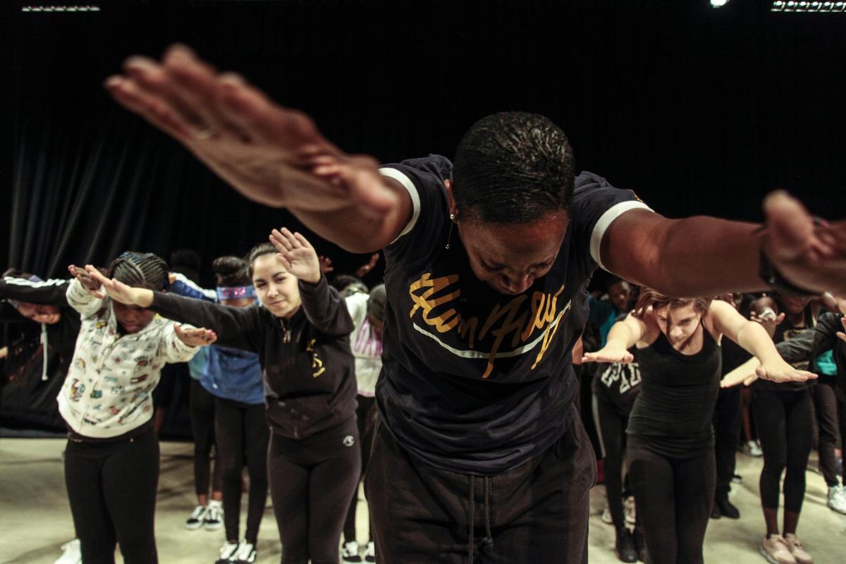 Nasha Thomas, left, goes over choreography with students from Richmond Heights Middle School at AileyCamp Miami at the Adrienne Arsht Center for the Performing Arts in Miami in this file photo from Feb. 7, 2019.