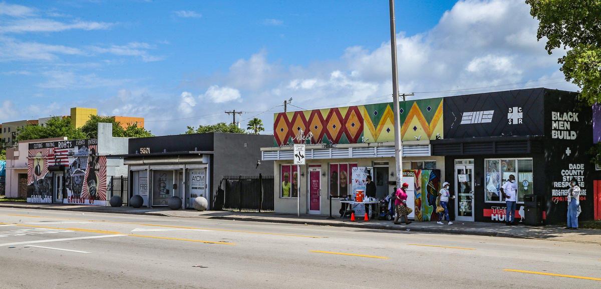 The Roots Collective Black House (far left) sits two doors down from the Village Free(dge) (second to right) and the Black Men Build hub far right) on the 5400 block of 7th Avenue in Miami, Florida on Wednesday, March 16, 2022.
