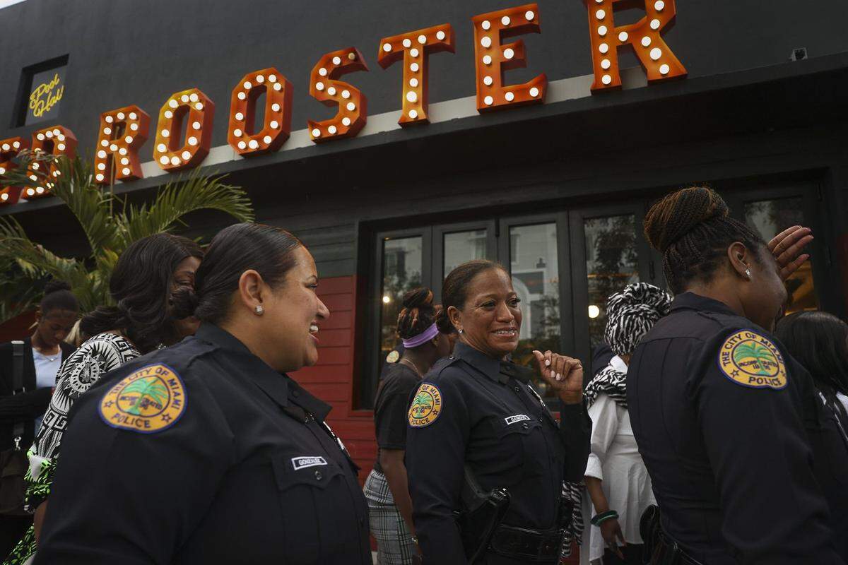 City of Miami Police officers gather in front of Red Rooster restaurant Thursday, May 18, 2023, for the Teen Talk etiquette luncheon. The women police officers were mentors to the girls and young women from Teen Talk and Girl Power Rocks, two Miami nonprofits that work with young people.